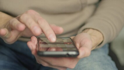 Aufkleber - A man's finger touches a monitor to scroll a page on a mobile phone. Viewing photos and documents in the smartphone library. A man in his hands uses a smartphone, turns pages.