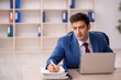 © Elnur - Young male employee and too much work in the office