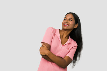 Poster - Young Indian woman cut out isolated on white background smiling confident with crossed arms.