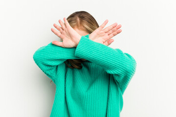 Young caucasian woman isolated on white background keeping two arms crossed, denial concept.