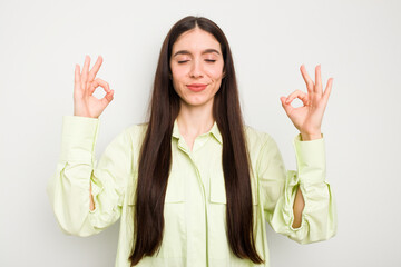 Wall Mural - Young caucasian woman isolated on white background relaxes after hard working day, she is performing yoga.