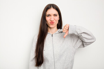 Wall Mural - Young caucasian woman isolated on white background showing thumb down, disappointment concept.