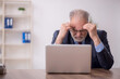 © Elnur - Old male boss employee working in the office