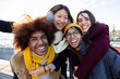 © Xavier Lorenzo - Happy multiracial young friends standing together outdoor smiling at camera. International friendship concept with group of four millennial people from diverse cultures having fun together