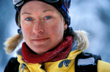A Portrait Of A Female Skier Wearing Ski Clothes.