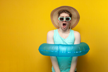 young guy with an inflatable swim ring is bound and limited in action and freedom, a man on vacation in the summer