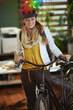 happy stylish business woman in bike helmet in eco office