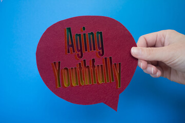Poster - Speech bubble in front of colored background with Aging Youthfully text.