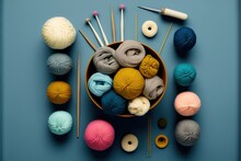 A Bowl Of Yarn And Knitting Needles On A Blue Surface With Balls Of Yarn And Needles In The Bowl And A Crochet Hook On The Side Of The Bowl With Yarn And A Crochet.