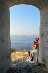 Wall Mural - Beautiful young couple bride and groom posing on Santorini island, Greece