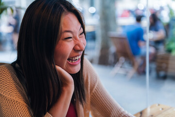 Wall Mural - portrait of a young asian woman laughing happy, concept of relaxation and leisure