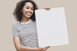 © kite_rin - Happy young woman holding blank white banner sign, closeup isolated studio portrait