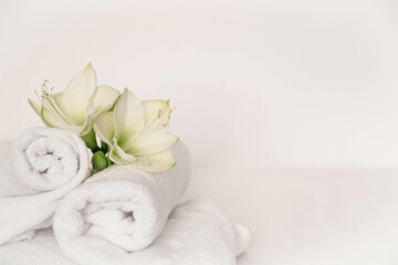 Wall Mural - Spa composition with lily flowers and towels on a white background.