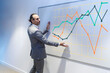 © Westend61 - Businessman explaining graph on whiteboard in conference room