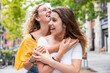 © Westend61 - Happy woman embracing friend on footpath
