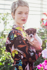 Poster - Close up pretty lady with cute puppy in garden portrait picture. Closeup side view photography with window on background. High quality photo for ads, travel blog, magazine, article