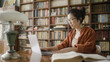 © Synthex - Young woman asian student sitting in library with laptop, studying or working