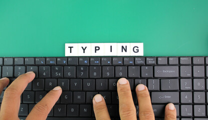 fingers press letters on laptop keyboard with word typing. the concept of typing