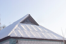 The Roof Of The Old House Is Covered With Snow