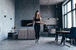© undrey - Fit woman skipping rope. Girl exercising with jumping rope at home.