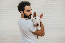 Bearded Man Hugging White Bull Terrier Dog