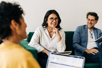 Canvas Print - Diverse business people having a meeting with their colleague in an office