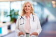© gzorgz - Senior female doctor portrait while standing at the clinic