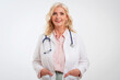 © gzorgz - Senior female doctor standing at isolated white background