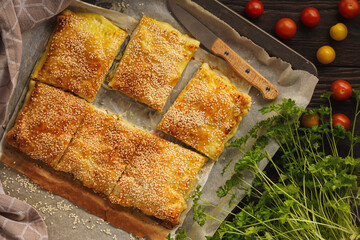 Wall Mural - Homemade crispy puff pastry pie with zucchini, ham and mozzarella.