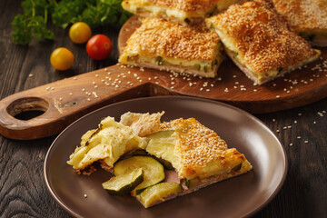 Wall Mural - Homemade crispy puff pastry pie with zucchini, ham and mozzarella.