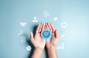 Leinwandbilder - Business hands holding target icon, dartboard and arrow for creative and set up business objective target goal, marketing solution, target for business investment.