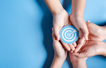 Fototapete - Business hands holding target icon, dartboard and arrow for creative and set up business objective target goal, marketing solution, target for business investment.