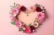 Valentine's Day flower arrangement in shape of a heart on pastel pink background