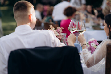 Wall Mural - bride and groom drinking champagne in the restaurant