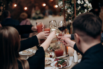 Wall Mural - people, celebration, party, holidays and drink concept-close up of woman hands holding champagne at restaurant