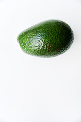 Wall Mural - Green avocado fruit on a white background. Juicy avocado fruit close-up.