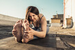 Woman Doing Yoga Stretching Outdoors On A Rooftop Terrace