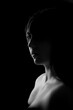 © Vera Kuttelvaserova - face of girl on a dark background with a back light