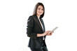 © muse studio - A woman in a business suit holds a tablet, looks at the camera, smiles, transparent background.