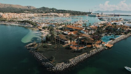 Wall Mural - Drone point of view Port of Alcudia town. Aerial shot of townscape and Mediterranean Seascape in the tourist resort of Majorca during sunny day. Travel and tourism concept. Balearic Island. Spain	