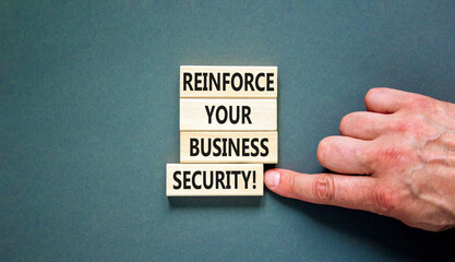 Wall Mural - Reinforce your business security symbol. Concept word Reinforce your business security on blocks. Beautiful grey table grey background. Business reinforce your business security concept. Copy space.