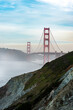 unique perspective on the Golden Gate Bridge in San Francisco with a mountain and a bit of fog in the foreground