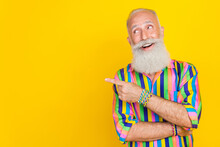 Portrait Of Cheerful Nice Granddad Toothy Smile Look Indicate Finger Empty Space Isolated On Yellow Color Background