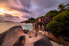 Tropical Beach With Granite Rocks At Sunset