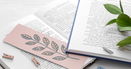 Poster - Open books with stylish bookmark on light background, closeup