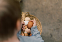Little Boy Holding A Basket Of Farm Fresh Eggs.