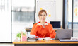 © David - Portrait young Asian woman working on laptop computer in office. documents tax business planning analyzing the financial report, business plan investment, finance analysis concept.