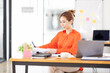 © David - Portrait young Asian woman working on laptop computer in office. documents tax business planning analyzing the financial report, business plan investment, finance analysis concept.