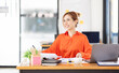 © David - Portrait young Asian woman working on laptop computer in office. documents tax business planning analyzing the financial report, business plan investment, finance analysis concept.