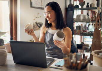 Wall Mural - Asian woman, laptop and pottery business with smile for creative startup holding ceramic creation in the workshop. Happy woman business owner smiling for art, design or clay craft by computer at work